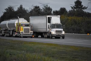 Two white trucks on a road