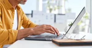 Man using a laptop to learn what UCR registration is and how to register.